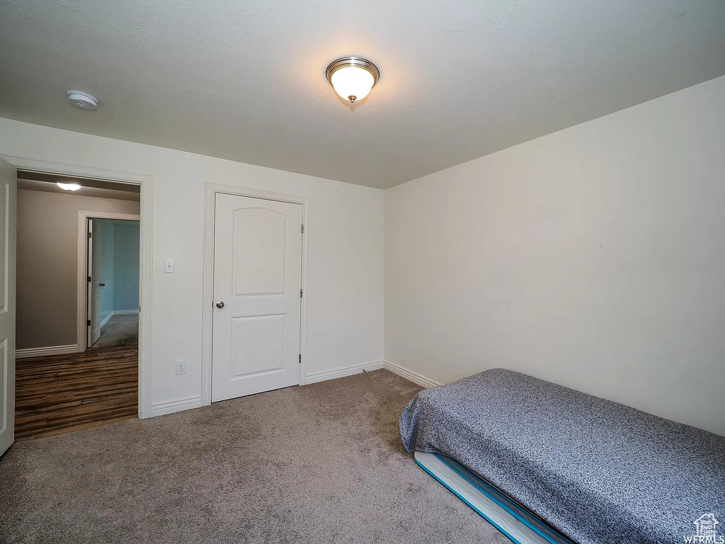 Bedroom featuring baseboards and carpet flooring