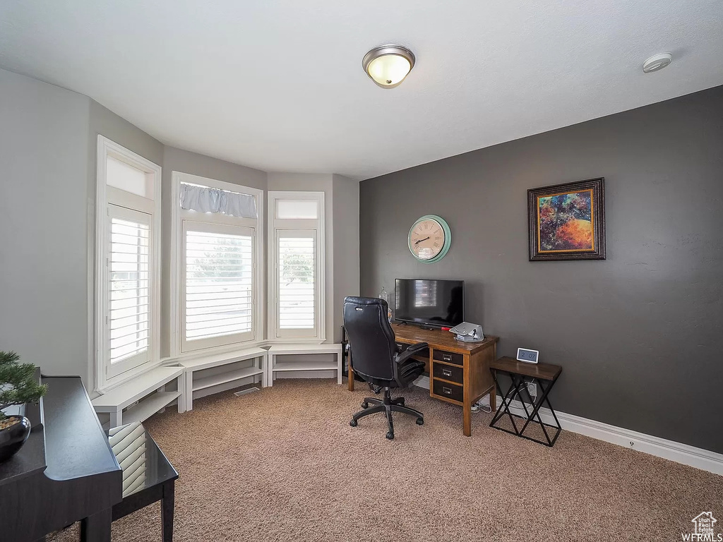 Carpeted office featuring baseboards