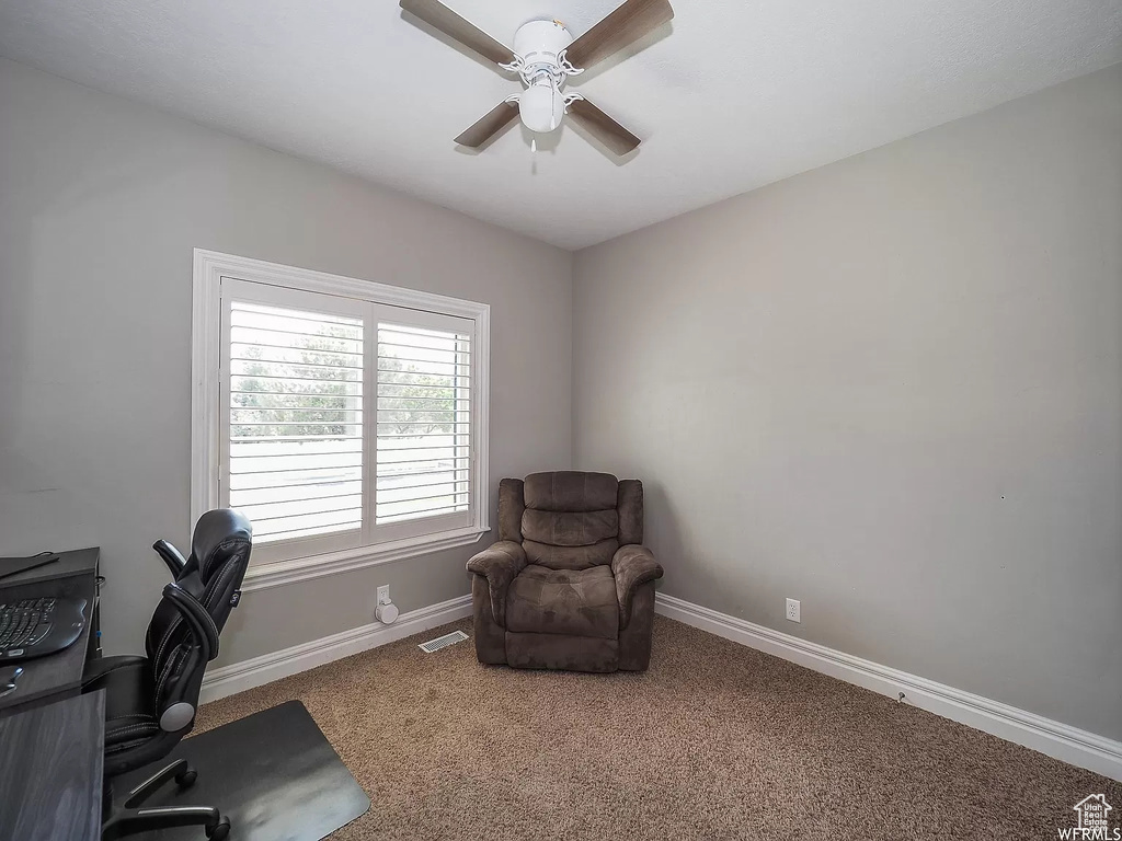 Office space with carpet floors, a ceiling fan, and baseboards