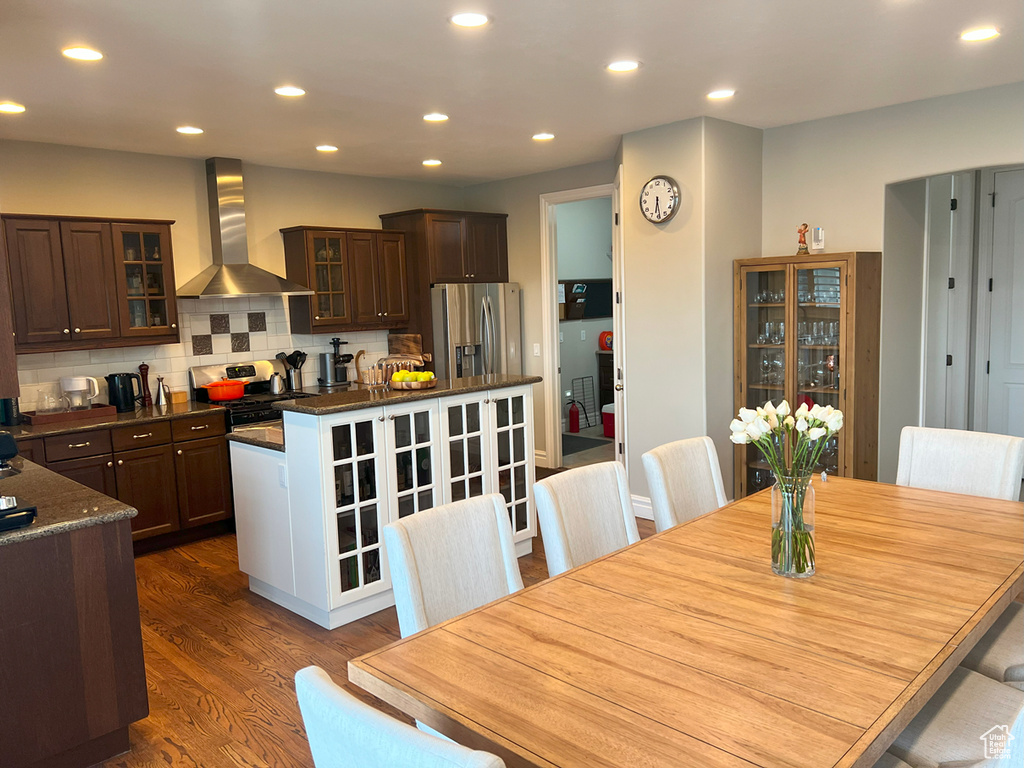 Dining area with dark wood-style floors and recessed lighting