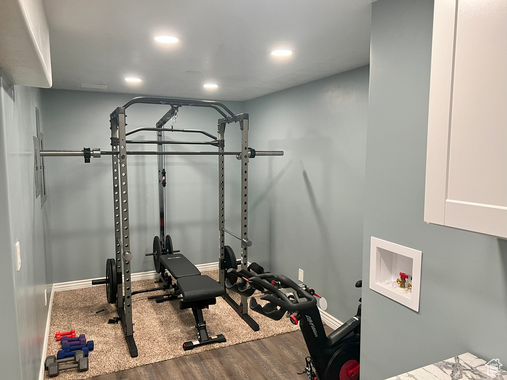 Workout room featuring wood finished floors, baseboards, and recessed lighting