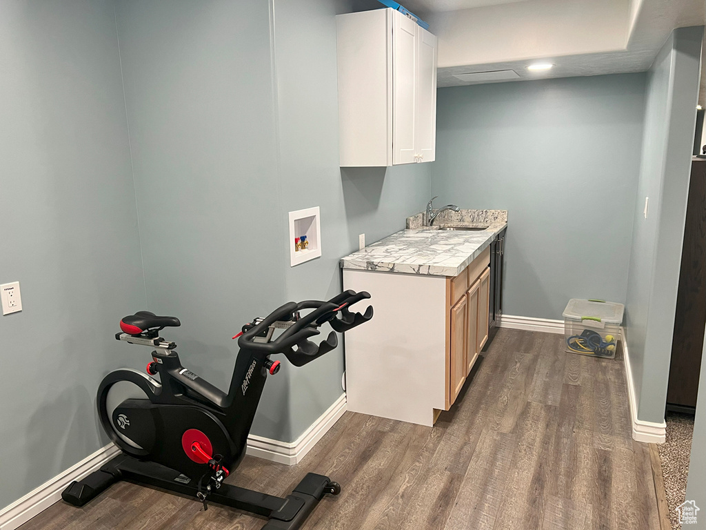 Laundry area featuring cabinet space, dark wood-style floors, baseboards, and hookup for a washing machine