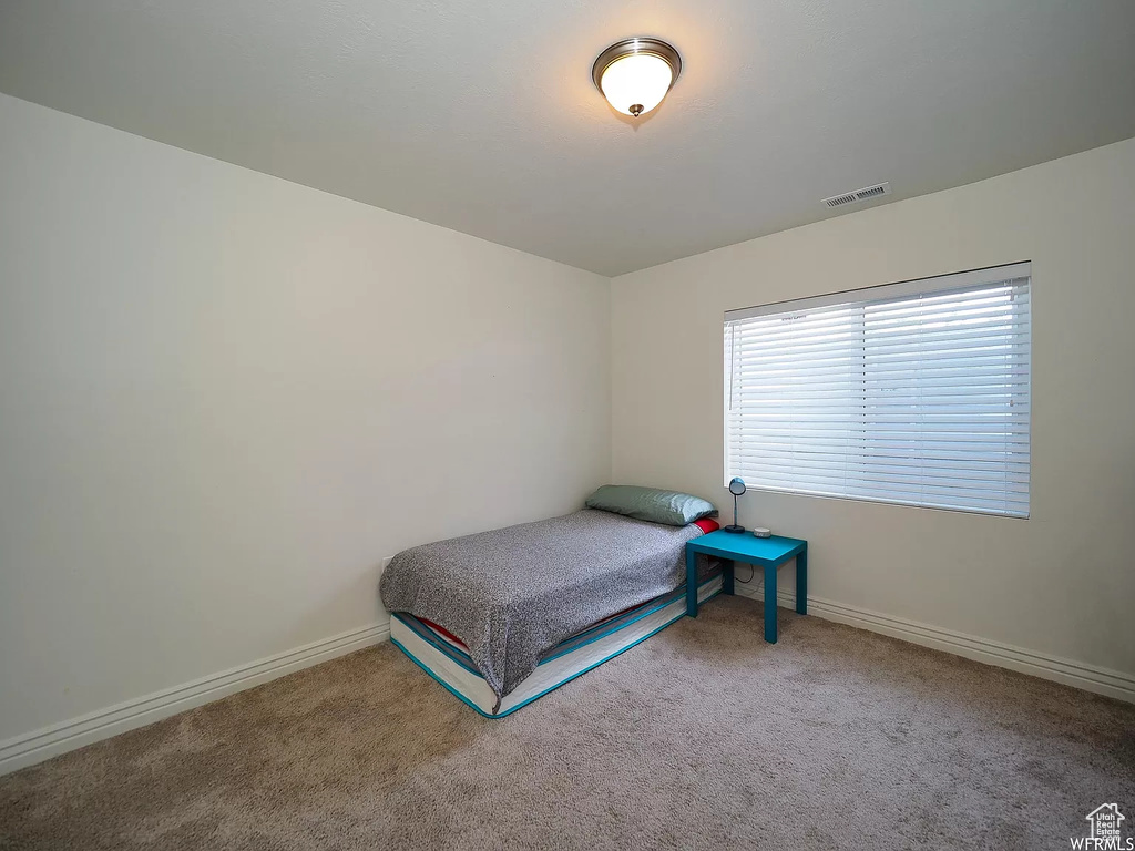 Carpeted bedroom with baseboards
