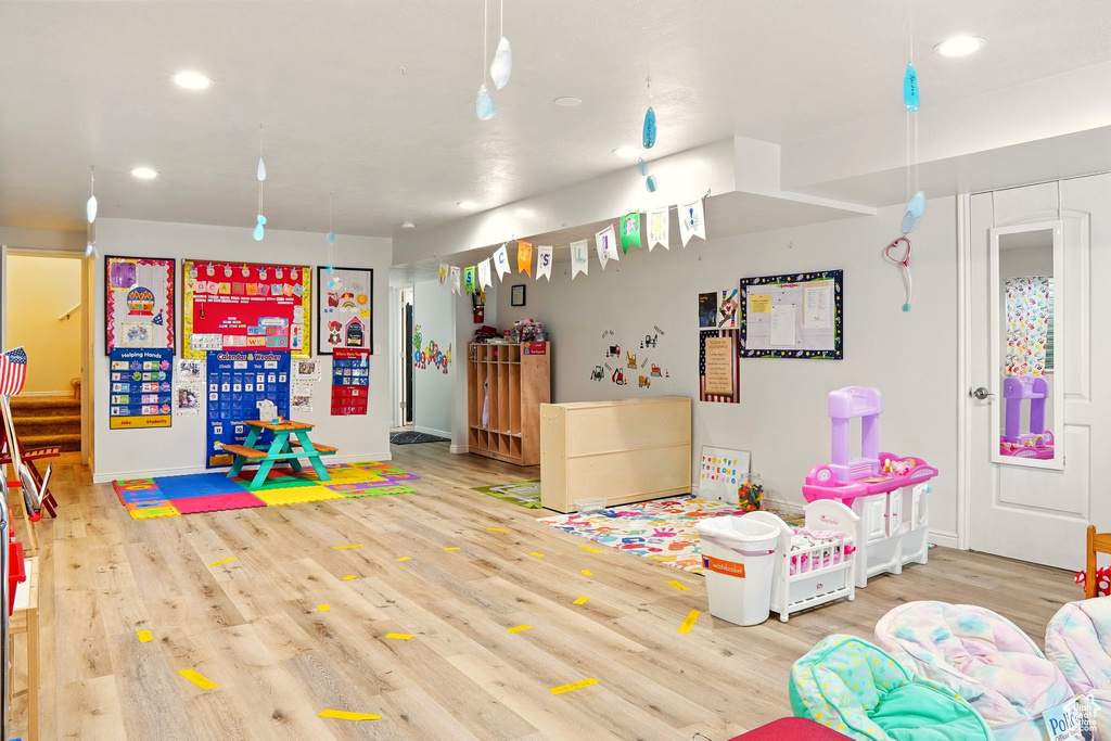 Playroom with wood finished floors, recessed lighting, and baseboards