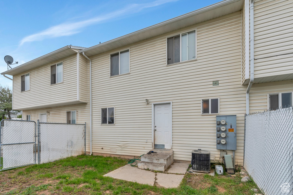 Back of property with fence and cooling unit