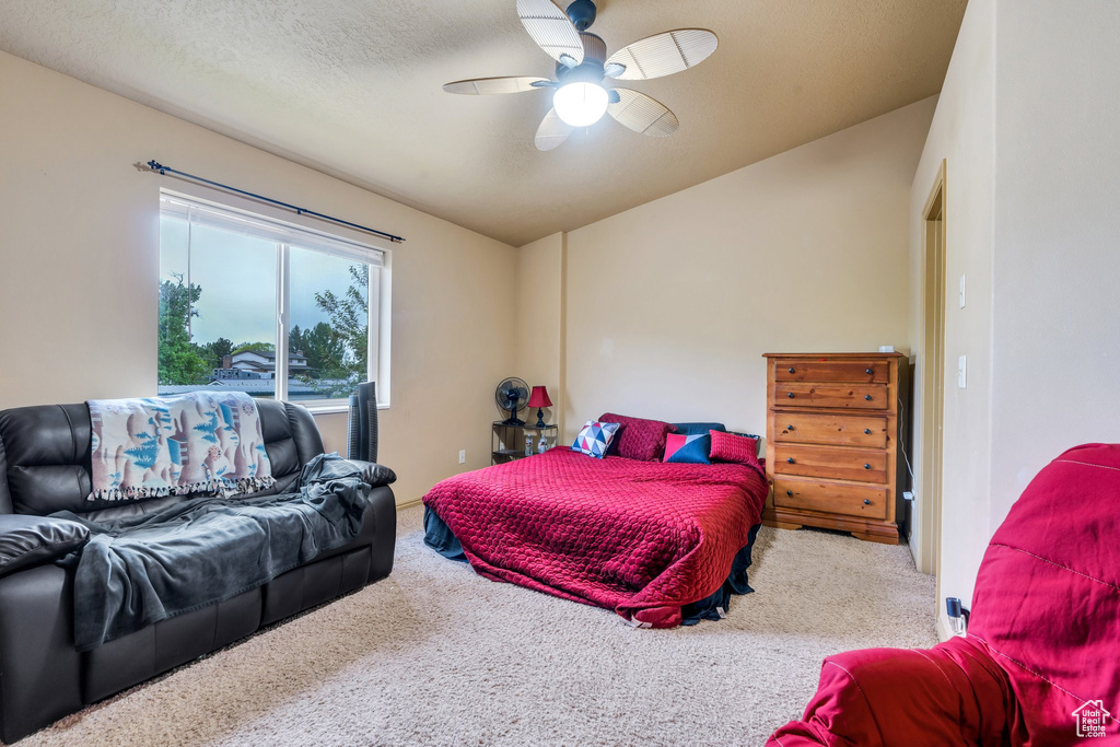 Bedroom with carpet floors, lofted ceiling, and a ceiling fan