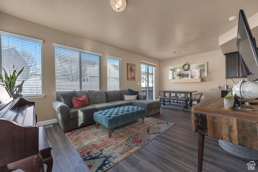 Living room with healthy amount of natural light, dark wood finished floors, and baseboards