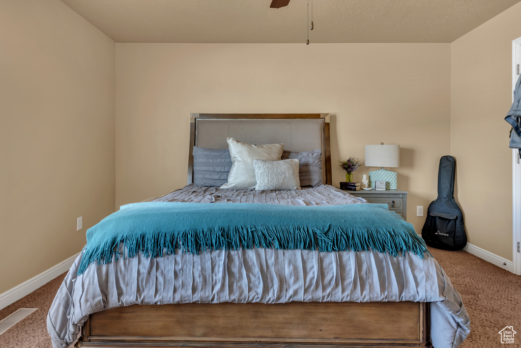 Carpeted bedroom featuring baseboards and a ceiling fan