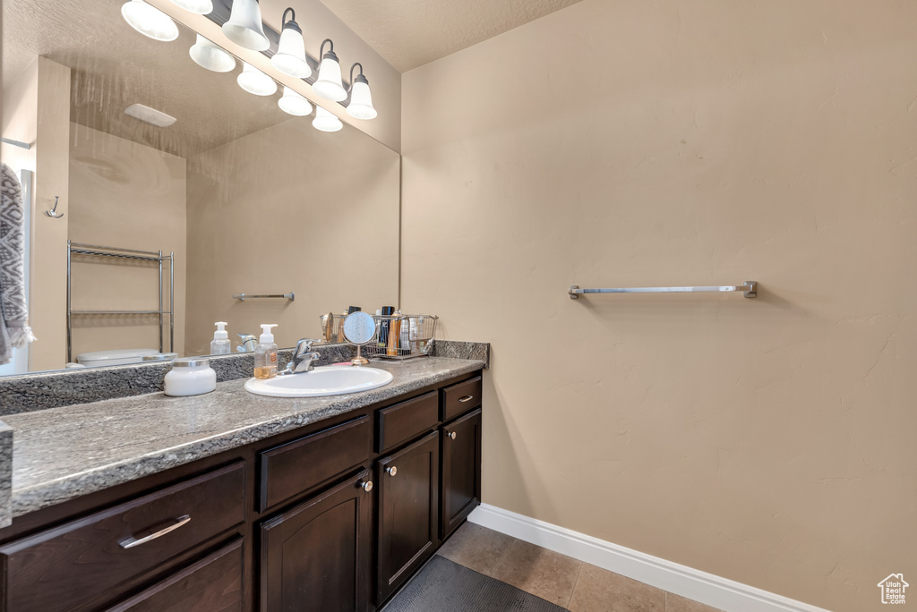 Bathroom featuring baseboards and vanity