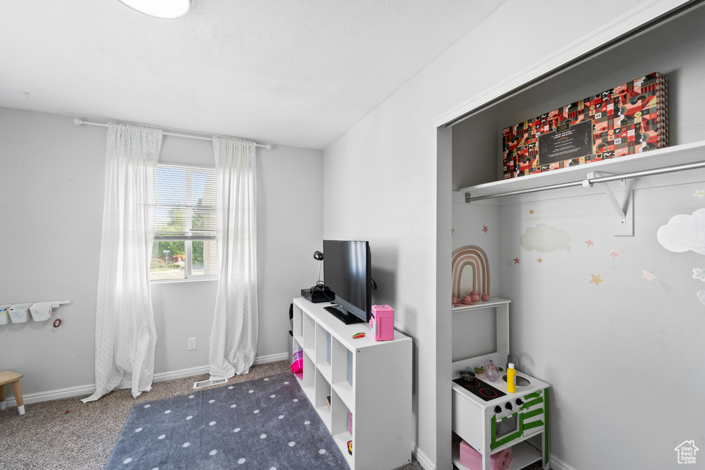 Recreation room with baseboards and carpet floors