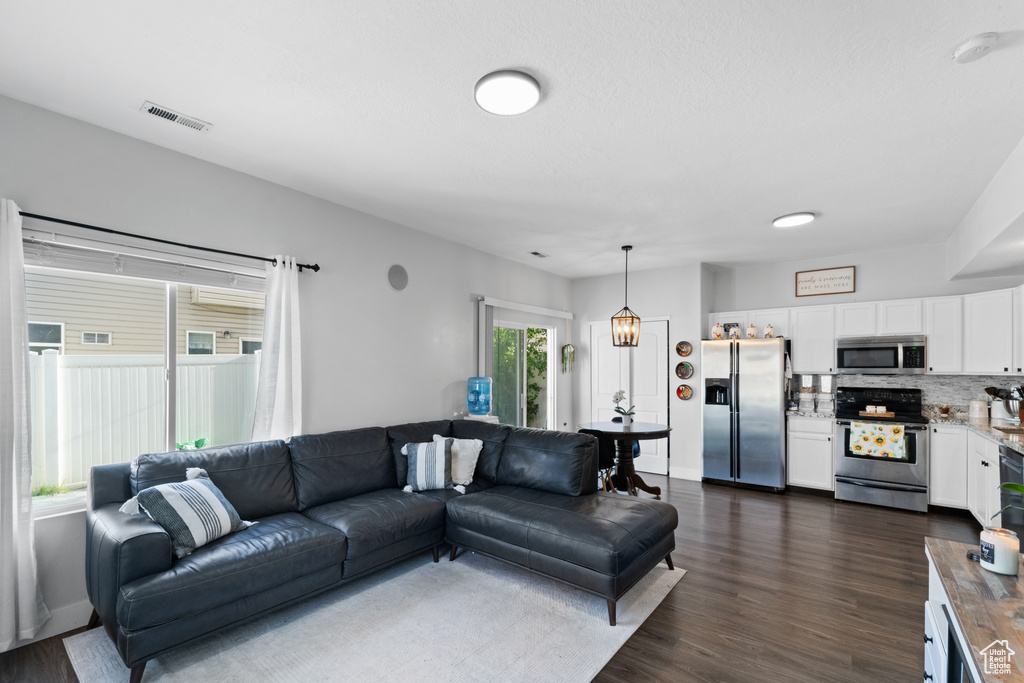 Living area featuring dark wood-style flooring