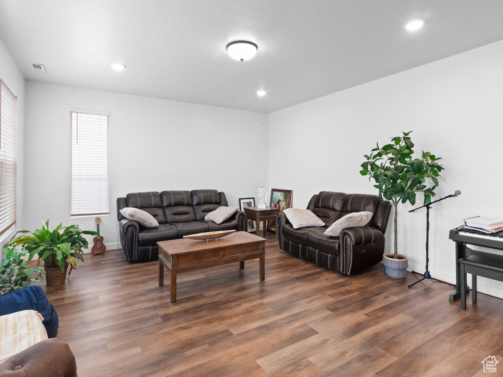 Living room featuring wood finished floors, recessed lighting, and baseboards