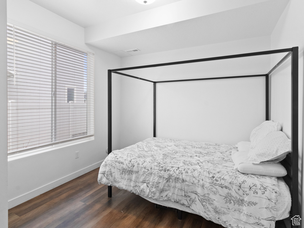 Bedroom featuring wood finished floors and baseboards