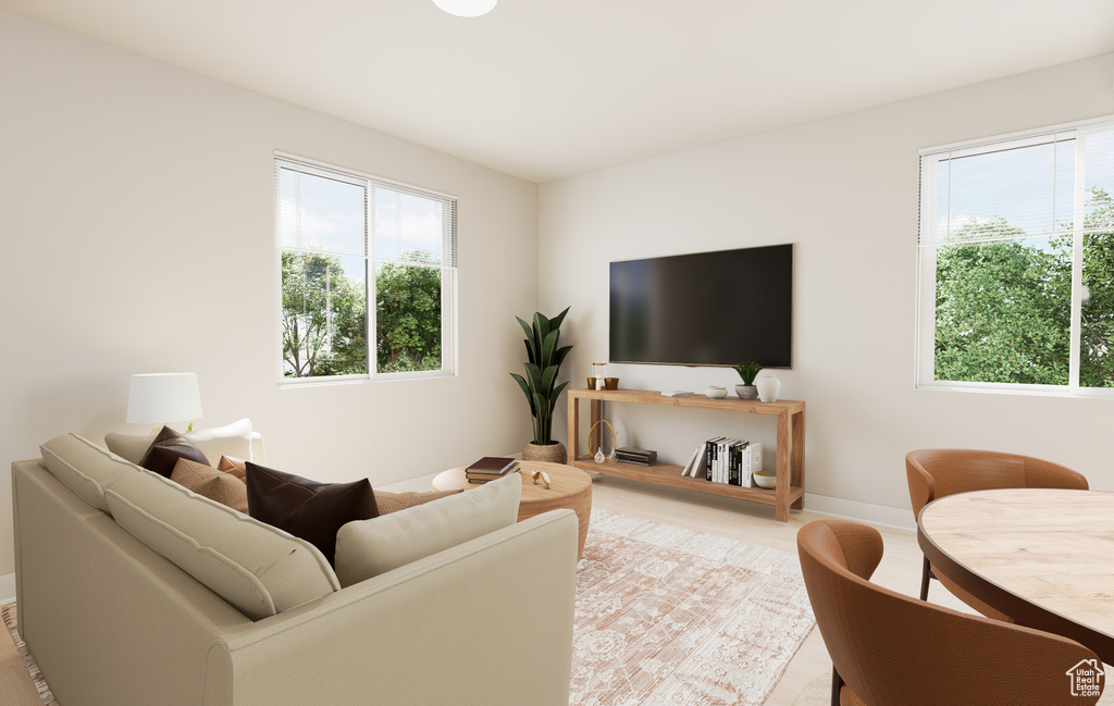 Living area with baseboards and light wood-style floors
