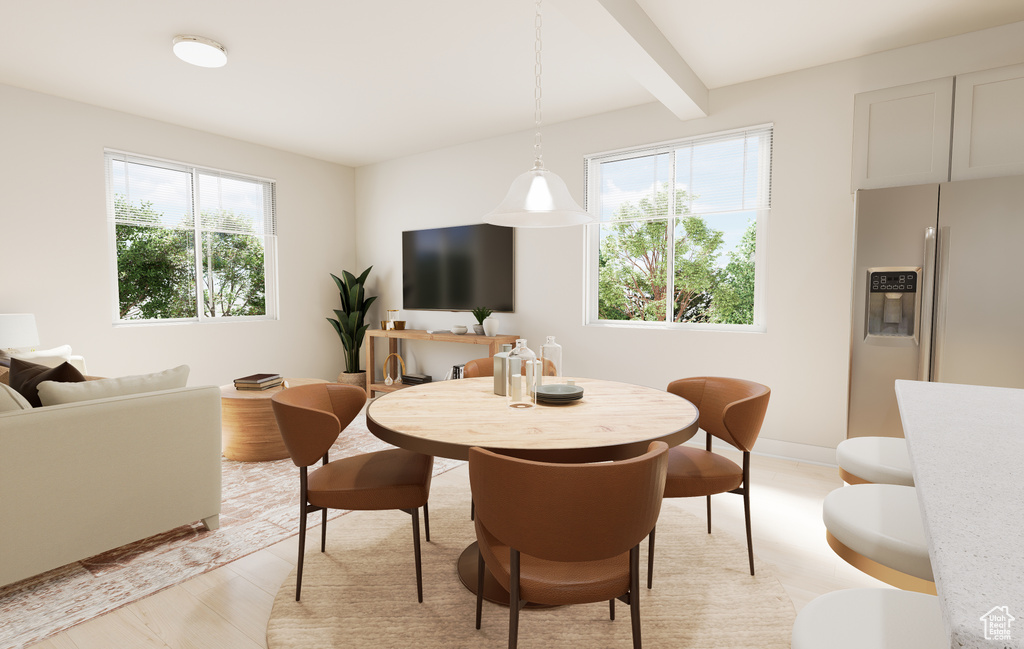 Dining space with healthy amount of natural light, beam ceiling, and baseboards