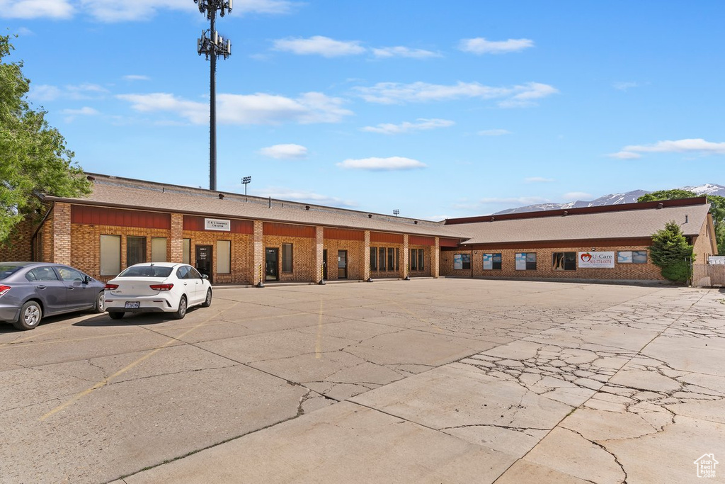 View of building exterior with uncovered parking