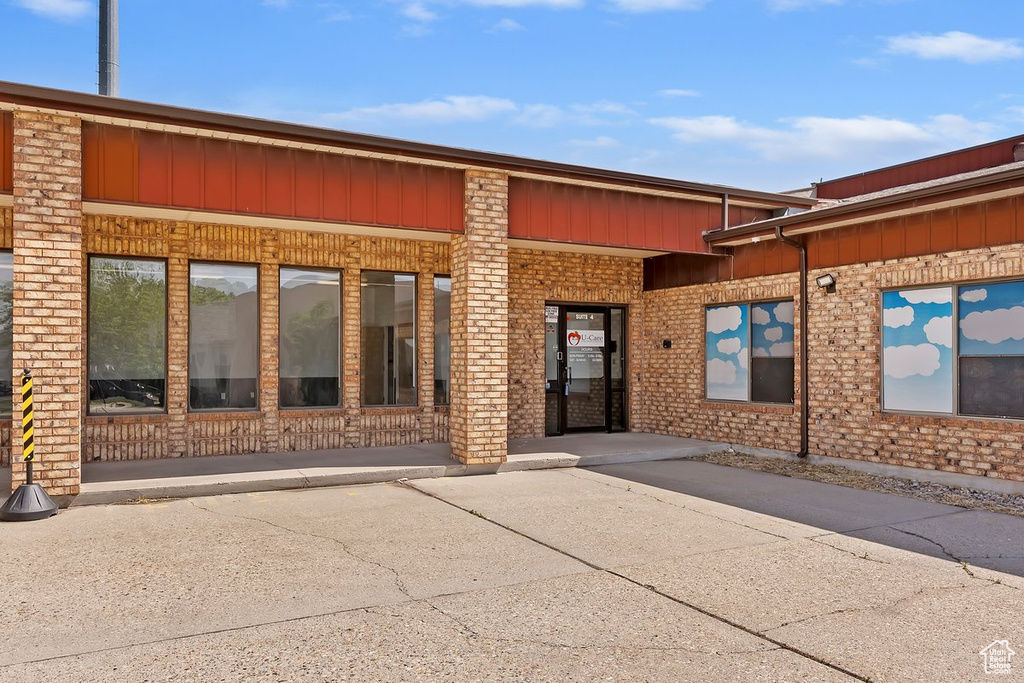 Entrance to property featuring brick siding and board and batten siding