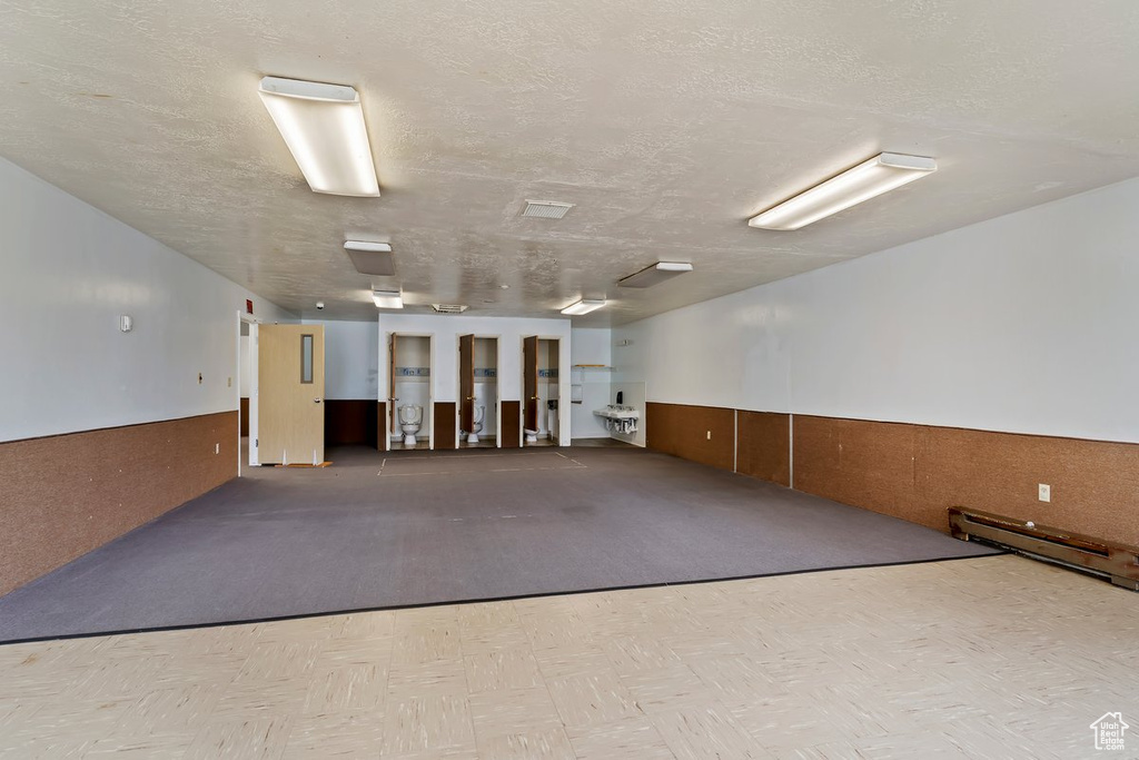 Carpeted empty room with a textured ceiling