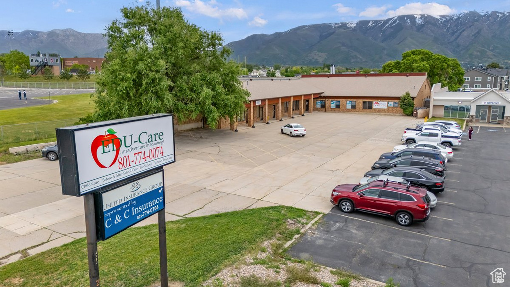 View of community with uncovered parking and a mountain view