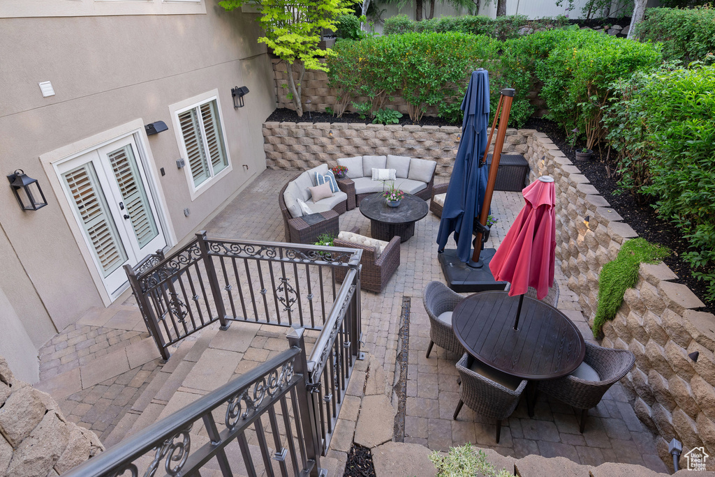 View of patio with french doors and an outdoor hangout area