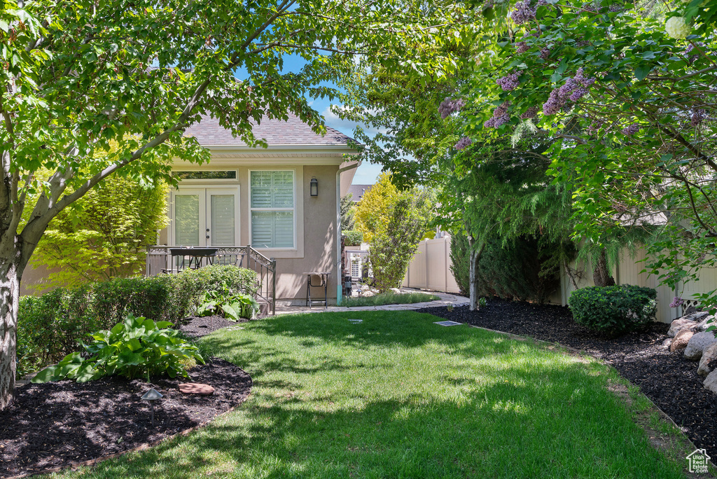 View of yard featuring french doors