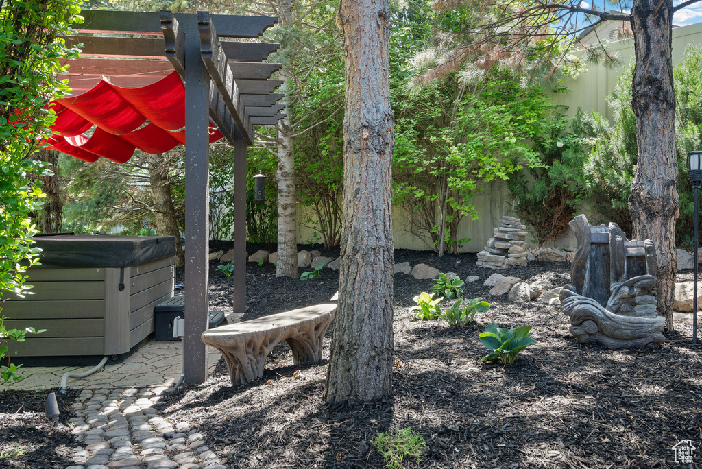 View of yard with a hot tub