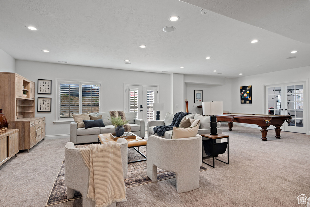 Living room featuring french doors, recessed lighting, light carpet, and billiards table