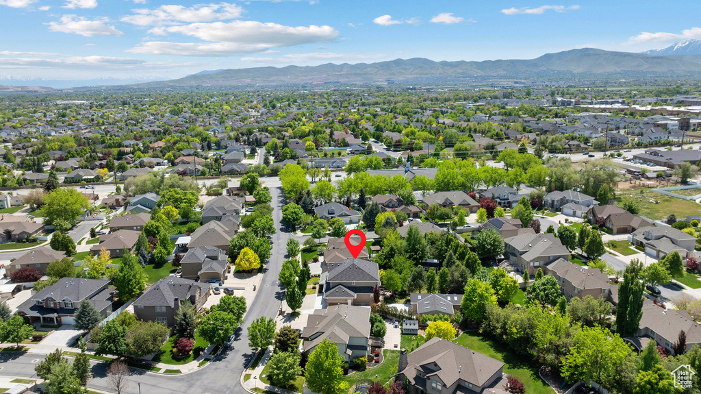 Aerial perspective of suburban area featuring a mountainous background
