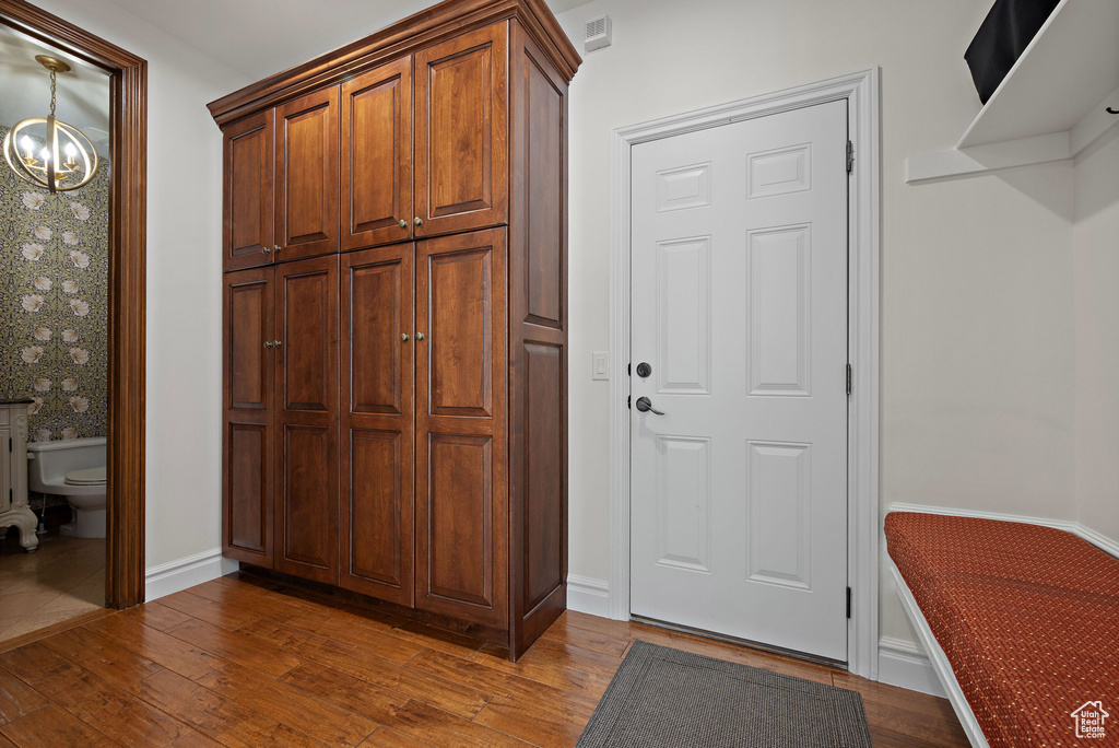 Interior space with hardwood / wood-style flooring, baseboards, and a chandelier