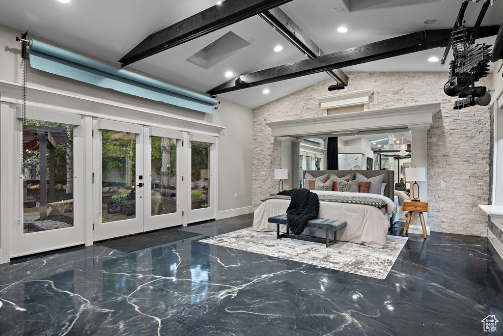 Bedroom featuring multiple windows, french doors, beamed ceiling, access to exterior, and decorative columns