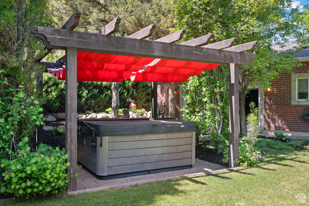 View of patio / terrace featuring a hot tub and a pergola