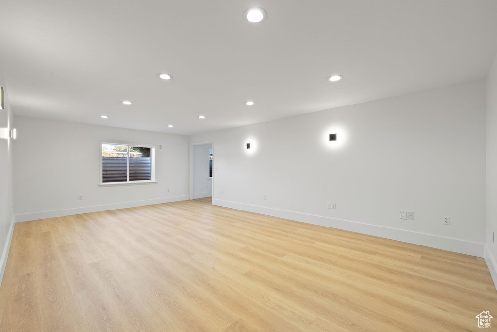 Empty room with recessed lighting, baseboards, and light wood-style floors