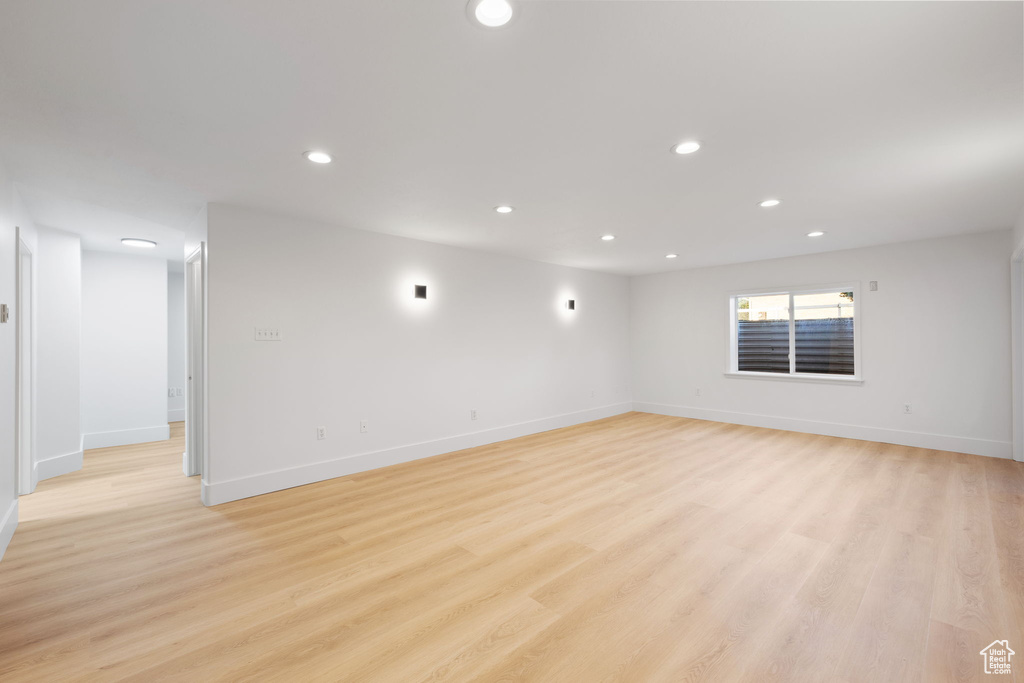 Spare room featuring recessed lighting, baseboards, and light wood-type flooring