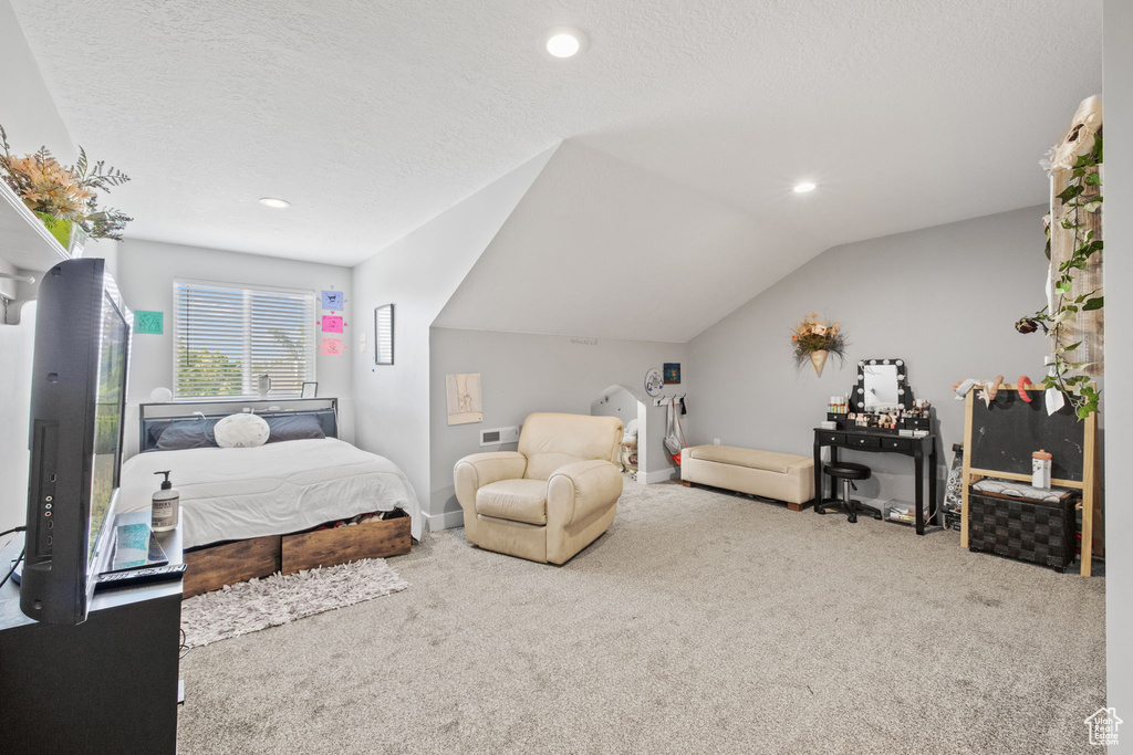 Carpeted bedroom featuring vaulted ceiling, recessed lighting, a textured ceiling, and baseboards