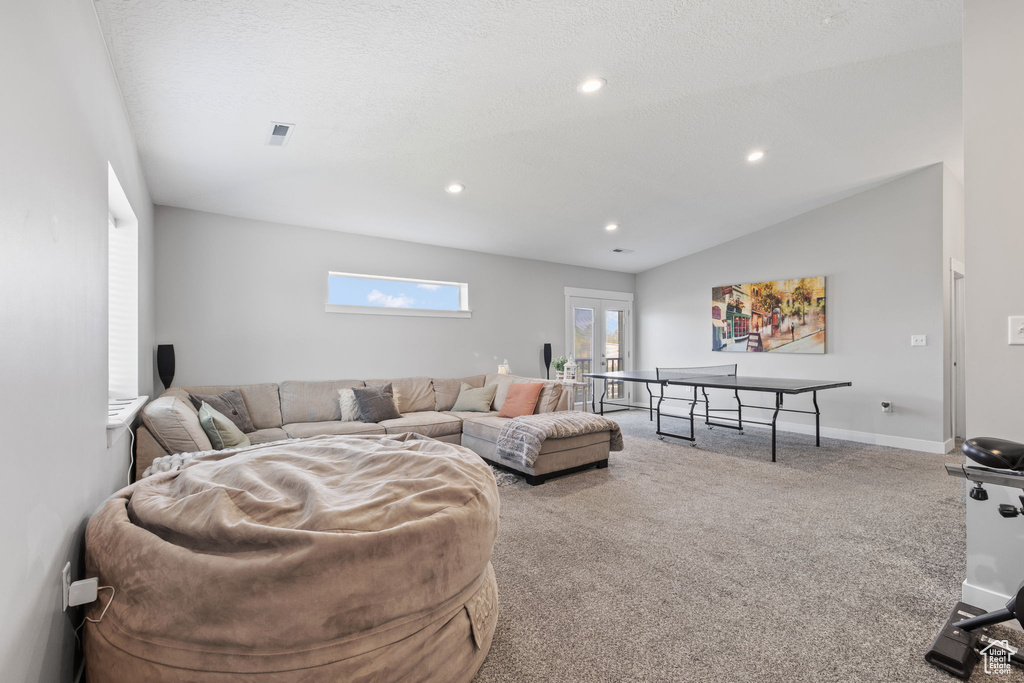 Carpeted living room featuring recessed lighting and baseboards