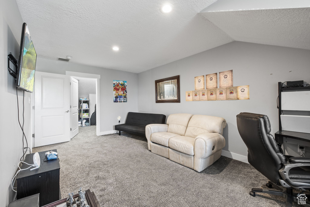 Carpeted office featuring a textured ceiling, baseboards, recessed lighting, and lofted ceiling
