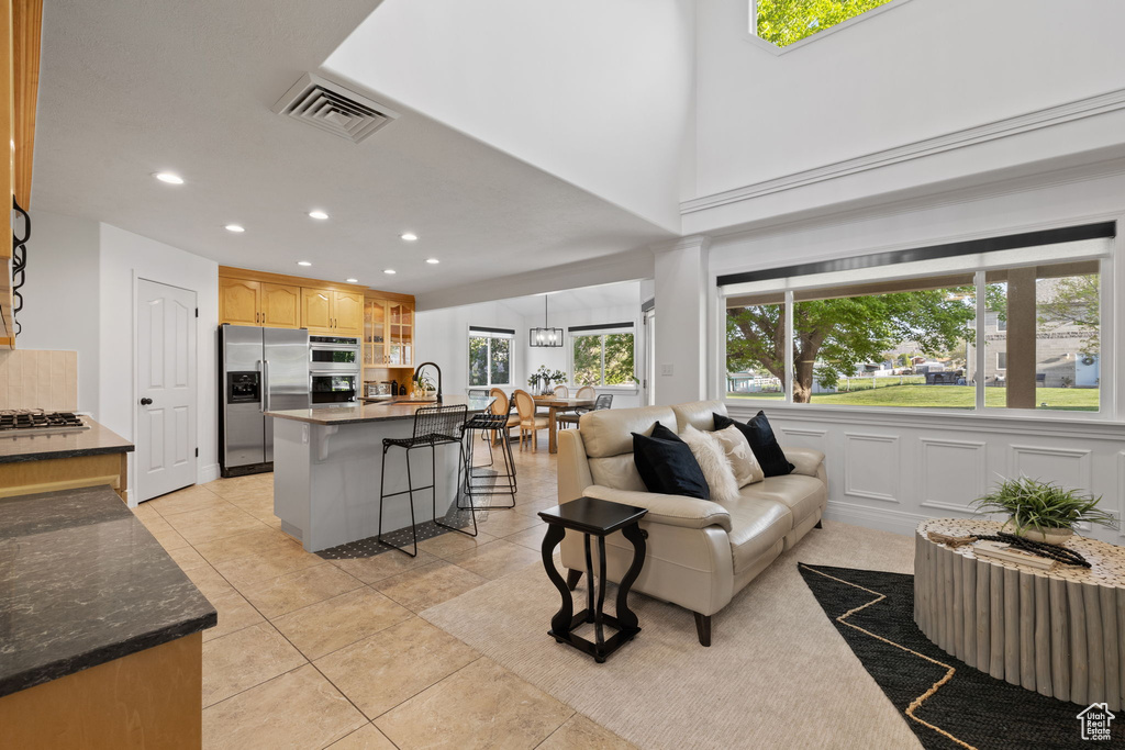 Living room with recessed lighting and light tile patterned flooring