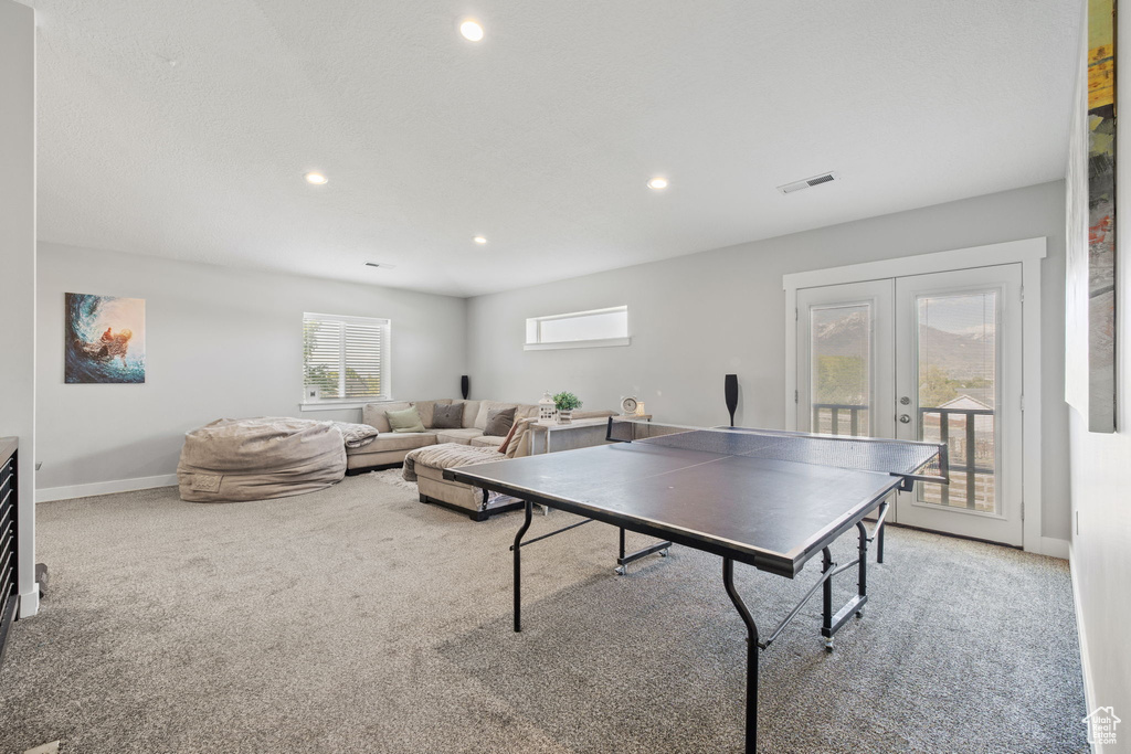 Recreation room with french doors, carpet floors, baseboards, and recessed lighting