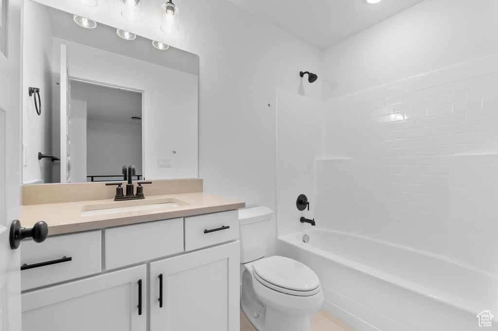 Bathroom with toilet, vanity, and shower / bath combination