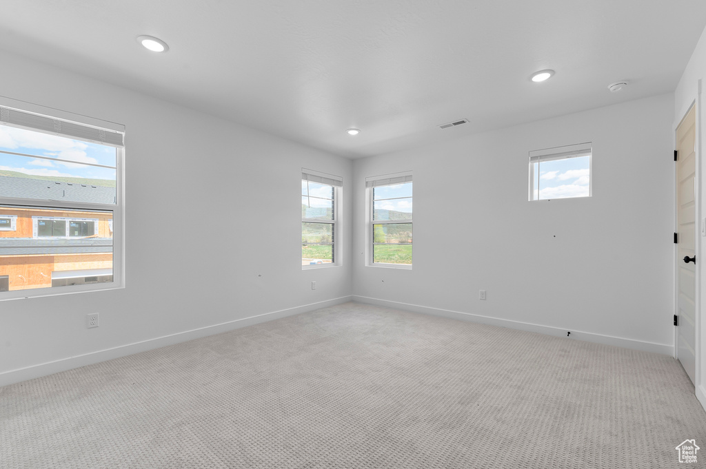 Unfurnished room with light carpet, baseboards, and recessed lighting
