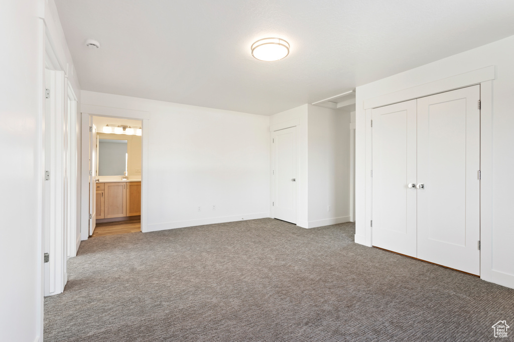 Unfurnished bedroom featuring carpet flooring and baseboards