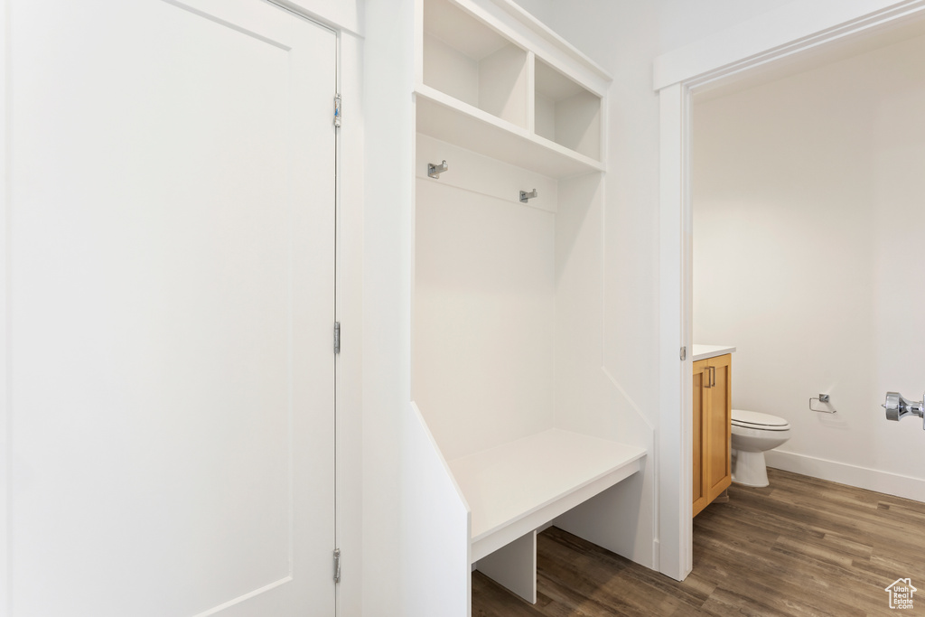 Mudroom featuring dark wood-type flooring and baseboards