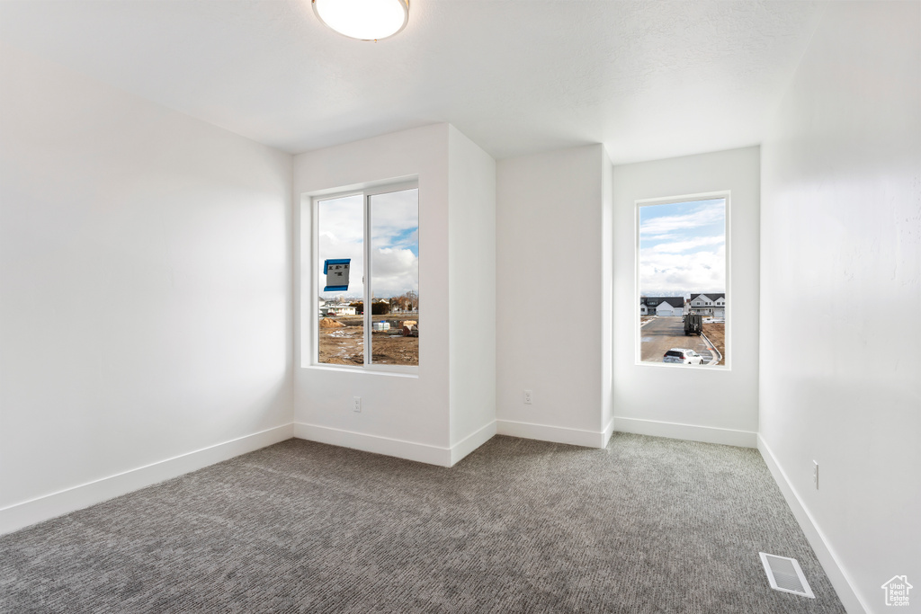 Carpeted empty room with baseboards