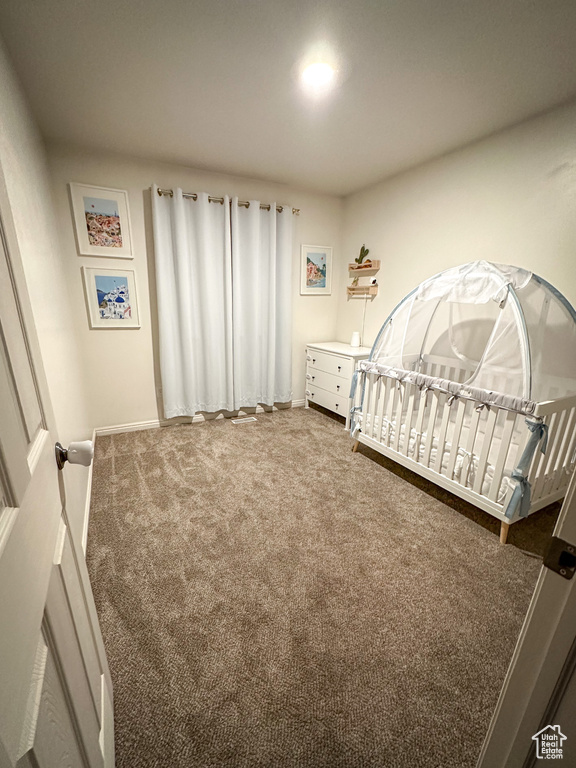 Carpeted bedroom featuring baseboards