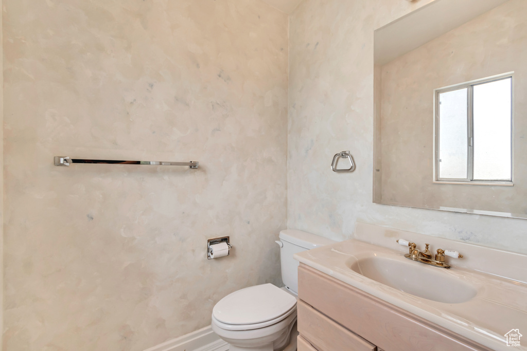 Half bathroom featuring toilet and vanity