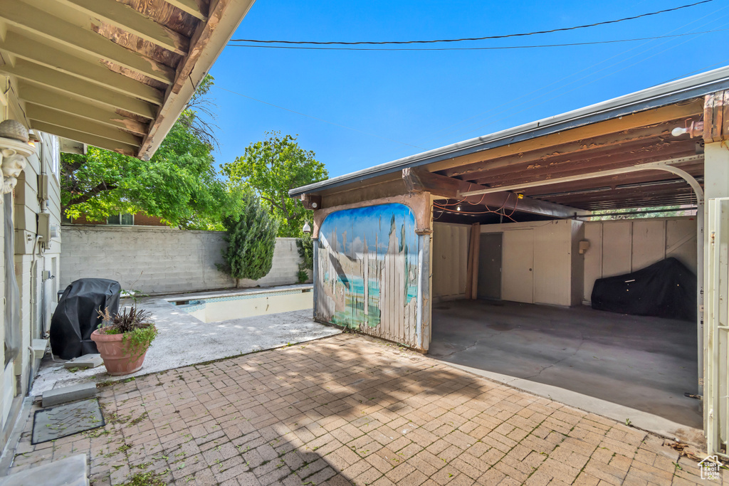 View of patio / terrace with a fenced backyard, a grill, and an attached carport