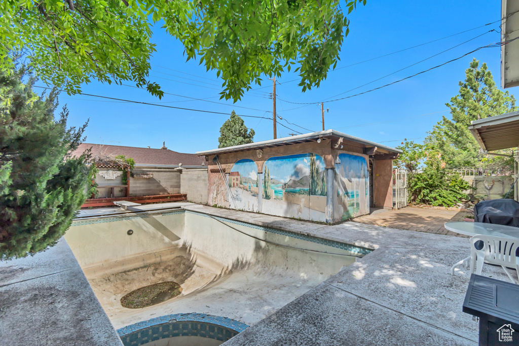 View of pool featuring a fenced backyard, a diving board, and a patio