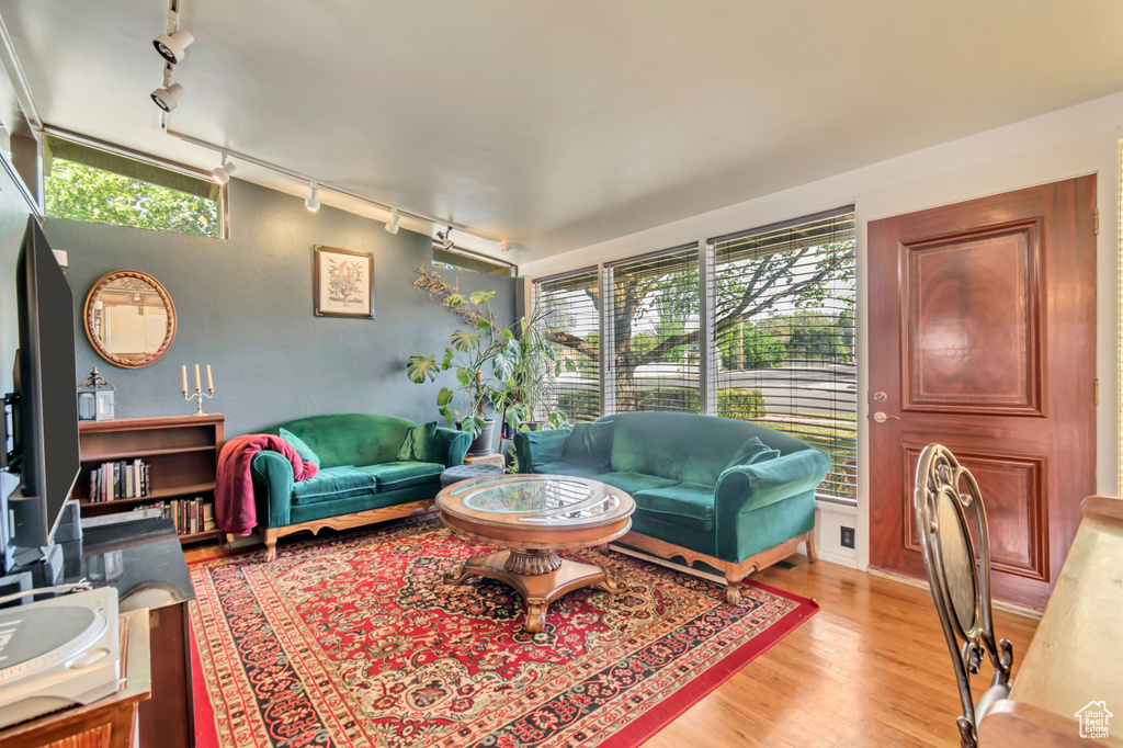 Living room featuring track lighting and light wood-type flooring
