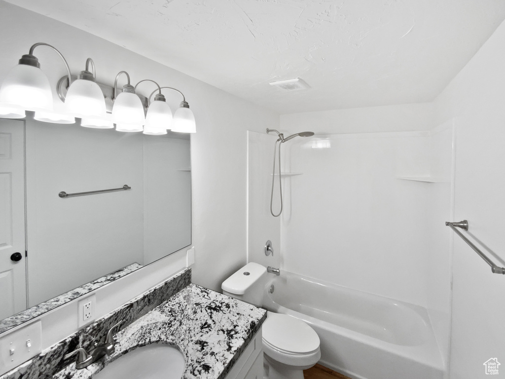 Full bath featuring toilet, shower / bathtub combination, and vanity