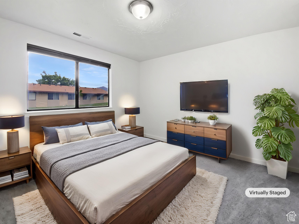 Bedroom featuring light carpet and baseboards
